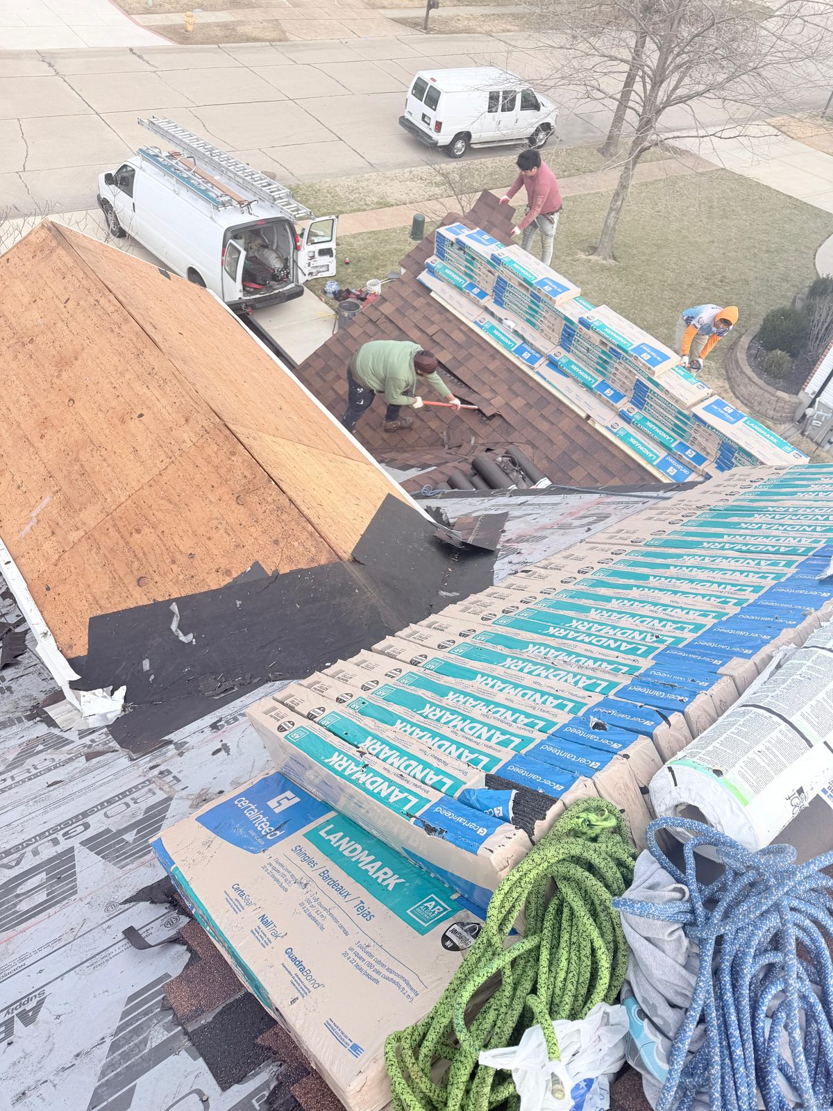 Three-person crew installing shingles